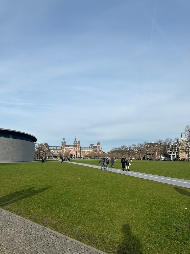 Green lawn of Museumplein with the Rijksmuseum in the distance